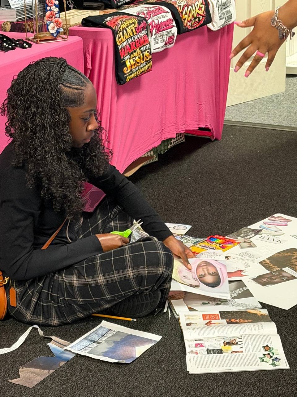 A sister cutting out magazine clippings for her vision board