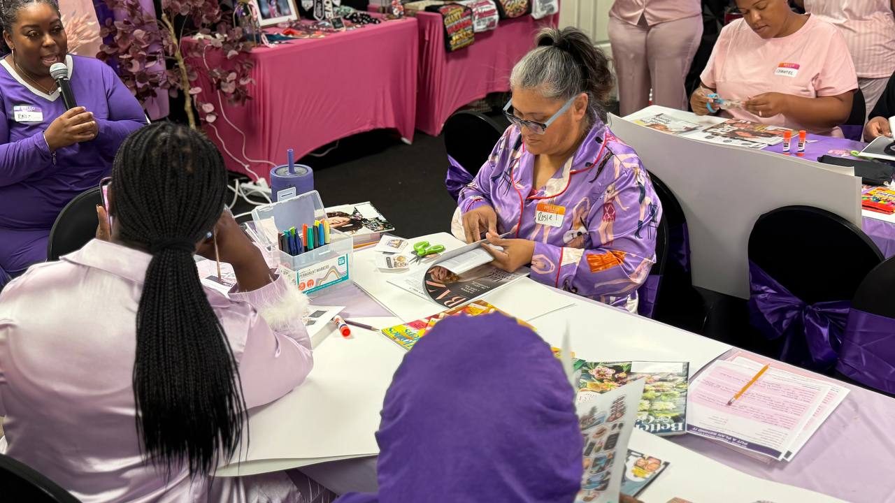 Sisters working on their vision boards at the tables