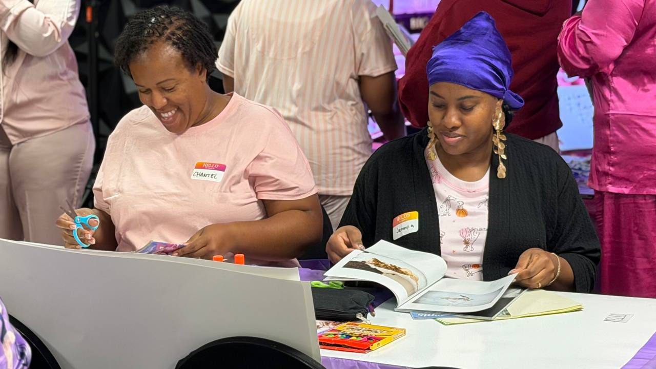 Two sisters smiling while flipping through magazines for their boards