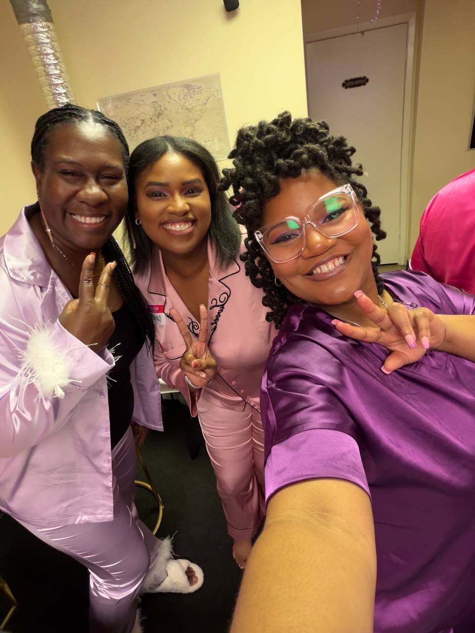 Three sisters throwing peace signs in a selfie